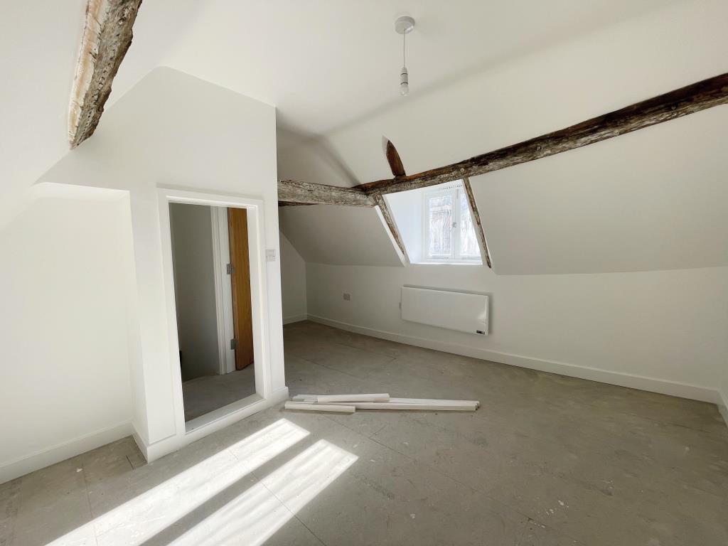 Lot: 161 - VACANT COMMERCIAL PREMISE WITH TWO FLATS ABOVE FOR COMPLETION - Second floor bedroom with exposed beam in Flat A
